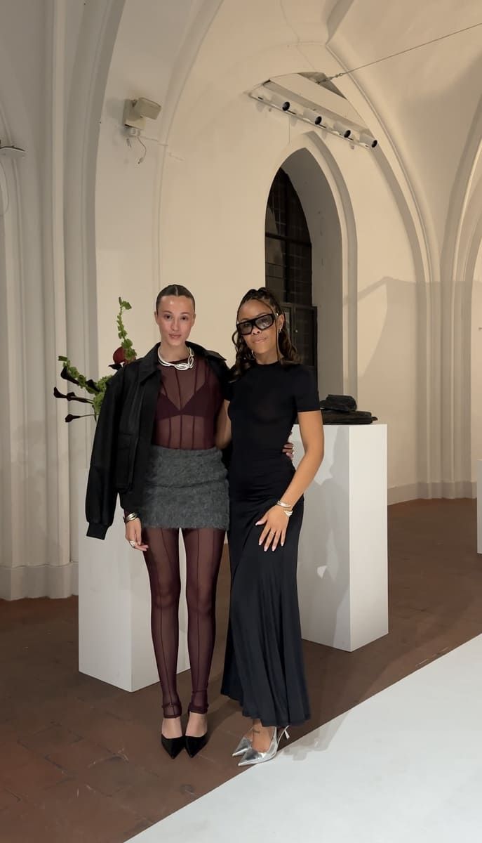 Josephine Højbjerg and Bathsheba pose together in a stylish, modern indoor setting.